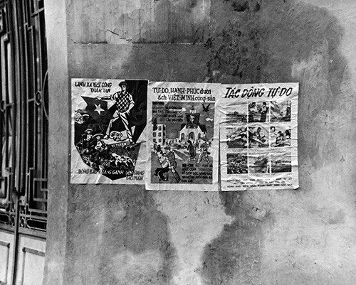 80-G-647018:  Passage to Freedom, September 1954.  Transportation of Vietnamese refugees to Saigon.   Propaganda posters on building in downtown Hanoi, Vietnam.   Official U.S. Navy Photograph, now in the collections of the National Archives. 