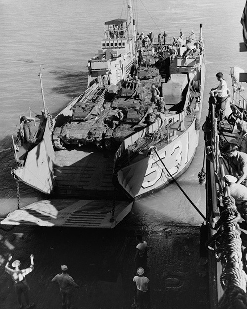 80-G-649028:   An LCU-531 ties up to USS Tortuga (LSD-26) in preparation for transferring a load of French tanks for transport to South Vietnam, August-September 1954.  Official U.S. Navy Photograph, now in the collections of the National Archives.