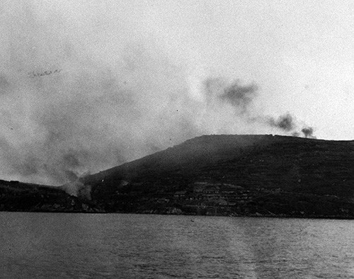 80-G-658104:   Evacuation of Chinese from Tachen Island off China.   Burning village on hillside.   Photographed by PH1 James Shea.   Photograph received on 2 March 1955.   Official U.S. Navy Photograph, now in the collections of the National Archives.  