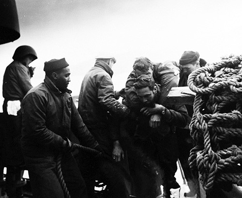 80-G-658113: Evacuation of Chinese from Tachen Island off China. Chinese National soldier fell overboard and was rescued by Boatswain’s Mate Second Class Bobbie F. Conine, USN. Photographed by PH1 James Shea. Photograph received 5 March 1955. Off...