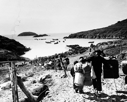 80-G-654920:   Evacuation of Chinese from Tachen Islands off China.  Long line of Chinese civilians and military personnel wait on beach to board ships of the Seventh Fleet.  Official U.S. Navy Photograph, now in the collections of the National Archives.  