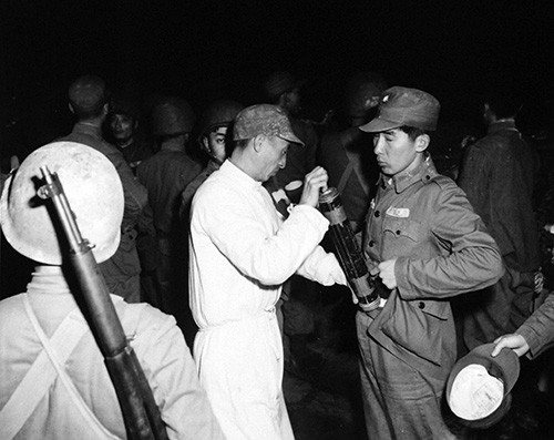 80-G-658119:  Evacuation of Chinese from Tachen Island off China.  Chinese soldier is being sprayed with DDT.   Photograph received 2 March 1955.  Official U.S. Navy Photograph, now in the collections of the National Archives.  