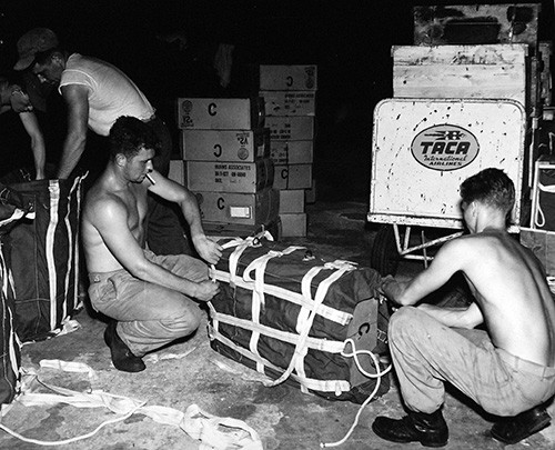 330-PS-7525 (USN 681152):   Marines Pack Food for Parachute Drop in Mexico.   Marine Corps personnel pack food for parachute drop to areas in Mexico stricken by Hurricane Janet.  The food was flown to Belize, British Honduras, in Navy aircraft for distribution to isolated areas which have been without food for days, October 5, 1955.  Official U.S. Navy Photograph, now in the collections of the National Archives.  