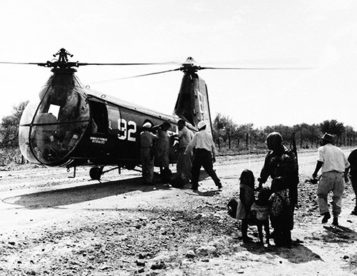 330-PS-7528 (USN 681155):   Navy Helo Evacuates Flood Victims.   A U.S. Navy helicopter from USS Saipan (CVL 48) brings Mexican woman and children to high ground at Tampico, Mexico.  Navy helicopters are carrying food, medicine, and doctors to the areas in Mexico stricken by Hurricane Janet and evacuating isolated people to high ground.   Saipan arrived on October 1, 1955, to aid in the Hurricane Relief Mission.   Official U.S. Navy Photograph, now in the collections of the National Archives.  