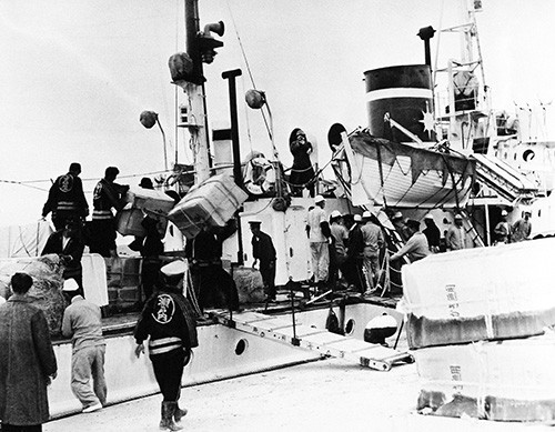 330-PS-9308-2:   U.S. Navy Aids Japanese Fire Victims, December 1958.    Koniya, Japan.  Shown:  U.S. Navy supplies being loaded off from a Japanese civilian ship to assist the people afflicted by the fire. Official U.S. Navy Photograph, now in the collections of the National Archives.   