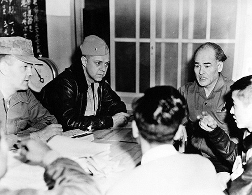 330-PS-9308-1:   U.S. Navy Aids Japanese Fire Victims, December 1958.    Koniya, Japan.   Shown:  Unidentified Seventh Fleet personnel discussing the situation with local Japanese.   Official U.S. Navy Photograph, now in the collections of the National Archives.   