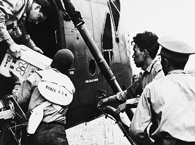 330-PS-9711 (428-GX-710557):   U.S. Navy and Japanese personnel work to unload supplies from a helicopter for flood victims of Typhoon Vera in Nagoya, Japan, 7 October 1959.  .  Official U.S. Navy Photograph, now in the collections of the National Archives.     
