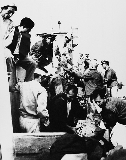 330-PS-9711 (428-GX-710558):   “C” Rations are off-loaded from a Japanese maritime self-defense force landing craft in one of the disaster areas of Nagoya, Japan.  U.S. Navy, Marine Corps and Japanese civilians work side by side to relieve the suffering caused by Typhoon Vera, 7 October 1959.   Official U.S. Navy Photograph, now in the collections of the National Archives.     
