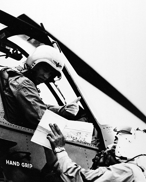 330-PS-9711 (428-GX-710556):  Lieutenant Junior Grade Joseph Greer, USN, pilot of US Navy helicopter from USS Kearsarge (CVA 33), receives briefing information from a Japanese pilot.  Helicopters were used to carry food, clothing, medical supplies, and other necessities to victims isolated by floods from Typhoon Vera, 7 October 1959.  Official U.S. Navy Photograph, now in the collections of the National Archives.     