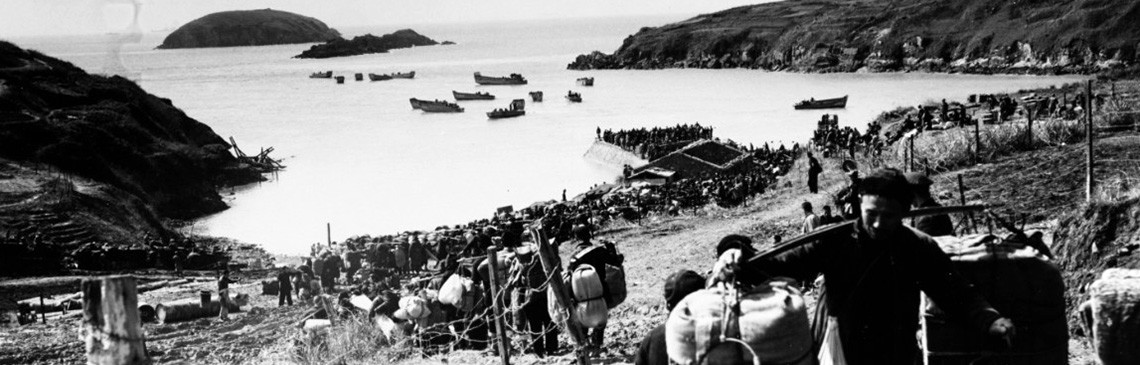 80-G-654920:   Evacuation of Chinese from Tachen Islands off China.  Long line of Chinese civilians and military personnel wait on beach to board ships of the Seventh Fleet.  Official U.S. Navy Photograph, now in the collections of the National Archives.  