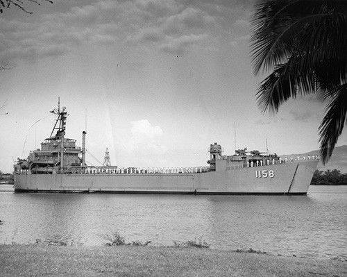 L45-283.04.01:  USS Tioga County (LST-1158), starboard view, arriving at Oahu, Pearl Harbor, with crew manning the rails, April 30, 1965.  NHHC Photograph Collection. 