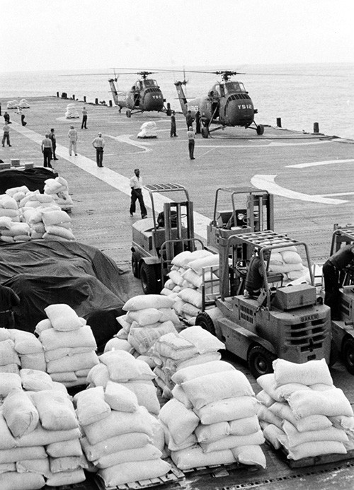 NH 93796:   USS Princeton (LPH-5), Marine UH-34 helicopters prepare to deliver food relief supplies to north South Vietnam, in late 1964.    NHHC Photograph Collection.  