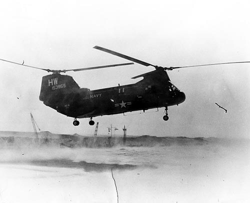 Showing the main hazard of flying helicopters in a desert environment, one of the CH-46’s from HC06, Det 9, lands beside the canal during a medevac call. Photographed by PH1 Joe Leo. NHHC Photograph Collection, Navy Subject Files.