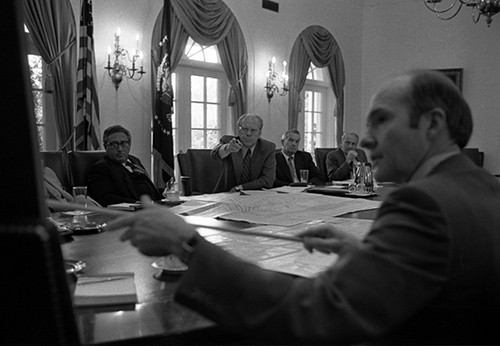 B0253-03A: President Gerald R. Ford and National Security Advisor Brent Scowcroft pointing to a map of Beirut, Lebanon, during the discussion of the evacuations, July 17, 1976. Note Secretary of State Henry A. Kissinger to the President’s right. ...