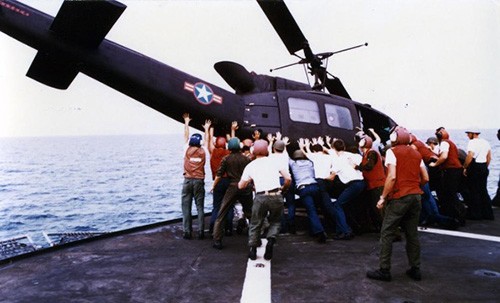 Operation Frequent Wind, April 29, 1975   A Vietnamese Air Force HU-1 Huey Helicopter is deliberately ditched near USS Blue Ridge (LCC-19), as one of the ship’s boats stands by to pick up the pilot.   This helicopter was one of 15 which landed on board USS Blue Ridge with Vietnamese military personnel and families during the evacuation.   The helicopters had to be pushed or ditched into the sea because of the lack of space on deck.  NHHC Photograph Collection, Navy Subject Files.