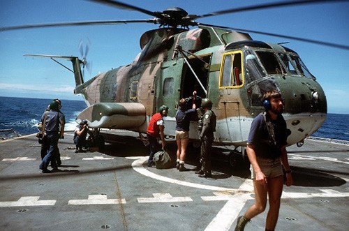 330-CFD-DN-ST-83-00822:  An Air Force HH-3 helicopter lands onboard USS Mount Hood (AE-29) assisting in salvage operations for the capsized Philippine destroyer Datu Kalanitaw. Photographed by PH2 Soutar, September 22, 1981.   Official U.S. Navy photograph, now in the collections of the National Archives.  
