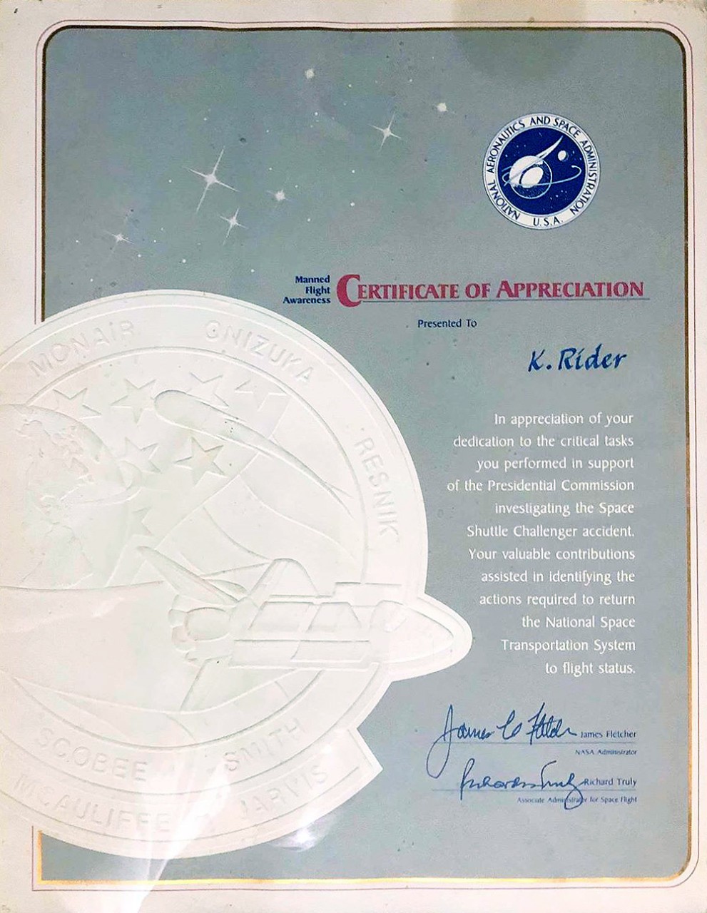 NASA Certificate of Appreciation for Manned Flight Awareness.    For U.S. Navy personnel who partook in the search for Challenger, NASA awarded these certificates which read, “In appreciation of your dedication to the critical tasks you performed in support of the Presidential Commission investigating the Space Shuttle Challenger accident.  Your valuable contributions assisted in identifying the actions required to return the National Space Transportation System to flight status.”  Signed by Mr. James Fletcher, NASA Administrator and Mr. Richard Truly, Associate Administrator for Space Flight.  The names of the Challenger crewmembers are on the insignia to the left.   Courtesy of Mr. Kevin Rider, crewmember of USS Dewey (DDG-45), whose ship partook in the initial search operation. 