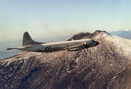 330-CFD-DN-SC-88-08331:   An air-to-air right side view of a P-3 “Orion” aircraft from Patrol Squadron 49 (VP-49) flying past Mount Etna while returning from a submarine tracking mission. The squadron, based in Jacksonville, Fla., is deployed to Sicily, August 1, 1985.   Official U.S. Navy photograph, now in the collections of the National Archives.   