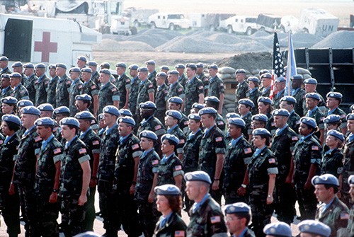 330-CFD-DF-ST-95-01571:   Soldiers, Sailors, Marines and Airmen of Joint Task Force Provide Promises stand in formation while the colors are being presented. They are being awarded the United Nations Medal for Service for the period of March 1994 through July 1994. The United States contingent provided critical humanitarian and medical aid to the people of the former Republic of Yugoslavia.  Photographed on July 4, 1994 by SSTG Russ Pollanean.  Official Department of Defense photograph, now in the collections of the National Archives