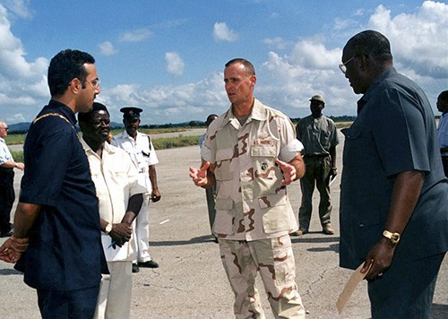 330-CFD-DM-SC-02-04671:  U.S. Marine Corps General William A. Whitlow talks with Hajib Balalab, Mayor of Mombasa, (left) and Major General Kibawana, Commander Kenya Navy, right) about the U.S. role in the flood relief.   Photographed March 2, 1998 by CPL M.A. Butler, USMC.  Official U.S. Marine Corps photograph, now in the collection of the National Archives.  