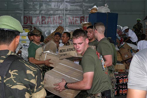 050104-M-9792P-027:   U.S. Marines work with Indonesian military personnel and international aid workers to sort and distribute humanitarian relief supplies stored in a warehouse at Palonia Air Field in Medan, Indonesia, January 4, 2005.    Photographed by Lance Cpl. Andreas A. Plaze.  Official U.S. Marine Corps photograph. 