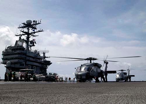 05015-N-1229B-211:   Two SH-60B Seahawks, assigned to Saberhawks of Helicopter Anti-Submarine Squadron Light Four Seven (HSL-47) refuel on the flight deck aboard USS Abraham Lincoln (CVN-72).  Photographed by Photographer’s Mate Airman Patrick M. Bonafede.  Official U.S. Navy photograph.  