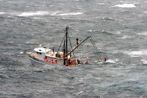 061201-N-6423H-006: The crew of the fishing vessel Miss Melissa await rescue from a boat crew deployed from the U.S. Navy’s amphibious transport dock ship USS San Antonio (LPD 17) making its way to the distressed vessel in heavy seas and 40 knot ...