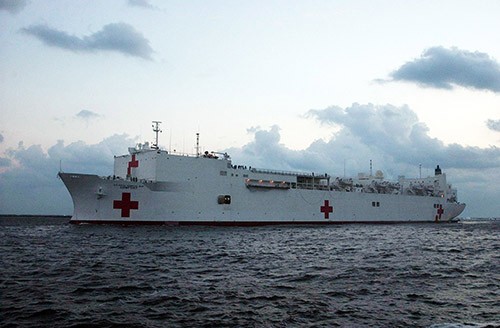 330-CFD-DN-SD-06-02871: Hurricane Katrina, 2005.   USNS Comfort (T-AH 20) pulls into the waters of Naval Station Mayport, Florida (FL), to take on supplies on its way to aid survivors of Hurricane Katrina, September 5, 2005.   Photographed by PM2 Kathleen A. Knowles, USN.  Official U.S. Navy Photograph, now in the collections of the National Archives.