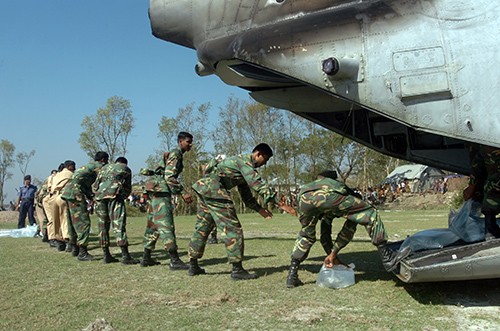 071126-N-1831S-113:  Members of the Bangladesh Army unloads bags of purified water from a CH-46 Sea Knight helicopter assigned to USS Kearsarge (LHD-3).   Photographed  on November 26, 2007 by Mass Communication Specialist Seaman Ash Severe.  Official U.S. Navy photograph. 