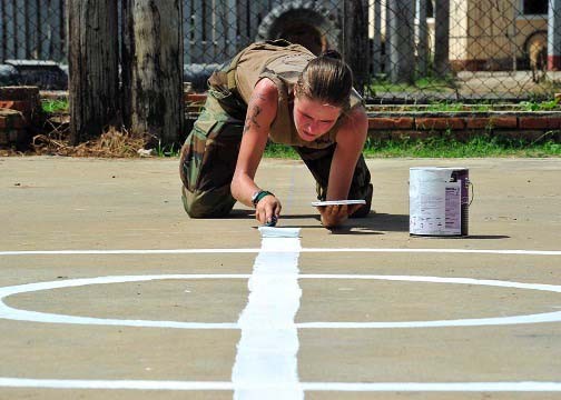 101025-N-1531D-035:   Steelworker Constructionman Lindzie Bicknell, assigned to Construction Maintenance Building Unit 202 of Naval Mobile Construction Battalion (NMCB) 7, embarked aboard USS Iwo Jima (LHD-7) paints lines for a new basketball court during Continuing Promise 2010.   Photographed in 2010 by Mass Communication Specialist 2nd Class Jonathen E. Davis. Official U.S. Navy photograph.  