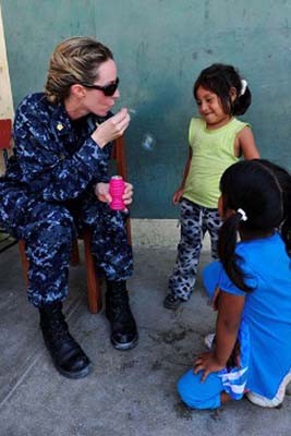 110506-F-NJ219-067:   Lieutenant Commander Michelle Carr blows bubbles for Peruvian children as they wait at a medical site during Continuing Promise 2011.   Photographed  in May 2011 by Sergeant Courtney Richardson.  Official U.S. Navy photograph.  
