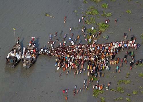 071124-M-3095K-030:   Bangladeshi citizens receive aid provided by boat in hard to reach areas of southern Bangladesh.  Photographed on November 24, 2007, by Sgt. Ezekiel R. Kitandwe.   Official U.S. Marine Corps photograph.  