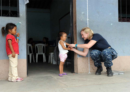 110701-T-EU-173-037:   Lieutenant Sara Edmonson talks with Guatemalan girl waiting to see a doctor during a Continuing Promise 2011 medical community service event in Puerto San Jose, Guatemala.   Photographed in July 2011 by Staff Sgt. Alesia Goosic.   Official Navy Photograph.  