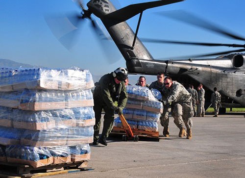 100115-N-47748-445:   U.S. Army soldiers help the crew of a U.S. Navy MH-53E Sea Dragon helicopter from the aircraft carrier USS Carl Vinson (CVN 70) unload food and supplies at the airport in Port-au-Prince, Haiti. The U.S. military is conducting humanitarian and disaster relief operations after a 7.0 magnitude earthquake caused severe damage near Port-au-Prince on Jan 12, 2010.   Photographed January 15 by MC2 Daniel Barker.   Official U.S. Navy photograph. 