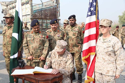 011110-A-NJ279-079:  Vice Admiral Michael A. LeFever, seated, signs a guest log during a farewell and a ceremonial end of humanitarian aid operations in Pano Aqil, Pakistan, Nov. 10, 2010. With the Pakistan military, U.S. Marines assigned to the 26th Marine Expeditionary Unit used CH-53E Super Stallion helicopters to transport more than 3.9 million pounds of World Food Program flood relief supplies to 150 locations in southern Pakistan.   Photographed by Spc. Stephen Schmitz, 2010.  Official U.S. Army Photograph.   