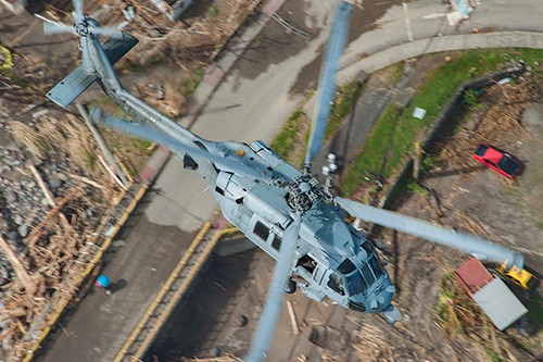 170925-N-NM806-0325:  An MH-60S Sea Hawk helicopter  flies over the island of Dominica during U.S. citizen evacuations and humanitarian relief following the landfall of Hurricane Maria. Photographed on September 25, 2017 by Mass Communication Specialist Seaman Taylor King.  Official U.S. Navy photograph.  