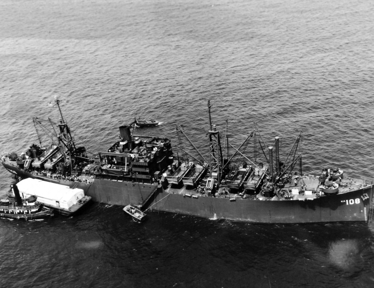 80-G-324143:  USS Washburn (AKA-108), May 1945.  Aerial at 300 feet.  Shown:  Broadside.   Photographed by Floyd Bennett Field aircraft, May 21, 1945.  Official U.S. Navy Photograph, now in the collections of the National Archives.  (2017/11/22).  Note, photograph is curved.   