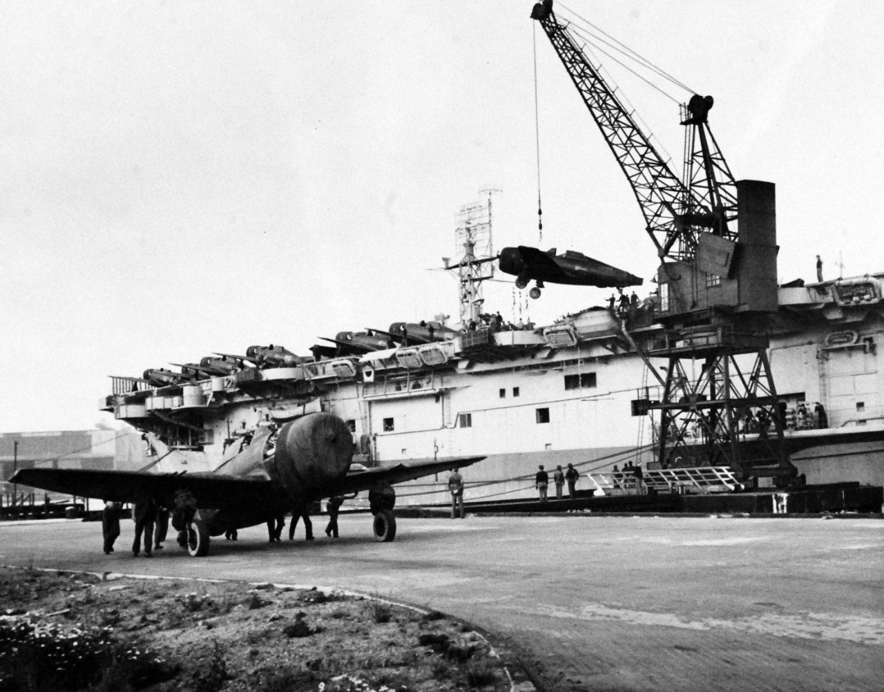 80-G-77756:   USS Block Island (CVE-21), 1943.   Unloading P-47’s at Belfast, North Ireland, July 27, 1943.  Official U.S. Navy Photograph, now in the collections of the National Archives.  (2015/03/04). 