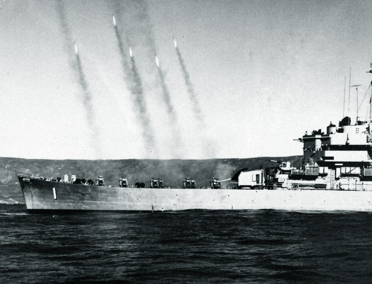 330-PS-7833:   USS Carronade (IFS-1), 1956.    Carronade fires a salvo of rockets during a recent amphibious training operation off the coast of Kauai, Hawaii.  The Carronade, a new type of navy ship, was designed to replace the LSMR (Medium Landing Ship, Rocket), which was employed during World War II to give close-in fire support to troops ashore.  The latest improvements in shipboard habitability have been incorporated in the design of the vessel.   Photograph released May 4, 1956.   Official DOD Photograph, now in the collections of the National Archives.  Also at the National Archives as USN 709597. (2015/02/25).  