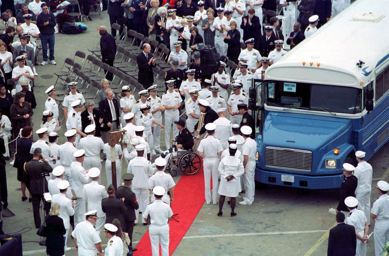330-CFD-DN-SD-03-12947: USS Cole (DDG-67).   Injured sailors from USS Cole (DDG-67) arrive for a memorial service held at Pier 12, Naval Station Norfolk, Virginia, October 18, 2000.   Official U.S. Navy photograph, now in the collections of the U.S. National Archives.