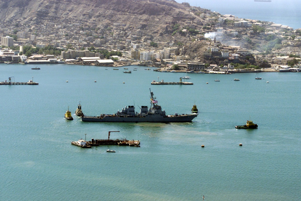 330-CFD-DN-SD-03-13099:   USS Cole (DDG 67) 2000.   Cole being towed from the Aden harbor, Yemen, October 29, 2000.  Official U.S. Navy photograph, now in the collections of the U.S. National Archives.