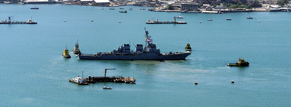 330-CFD-DN-SD-03-13099:   USS Cole (DDG 67) being towed from the Aden harbor, Yemen, October 29, 2000.  Official U.S. Navy photograph, now in the collections of the U.S. National Archives.