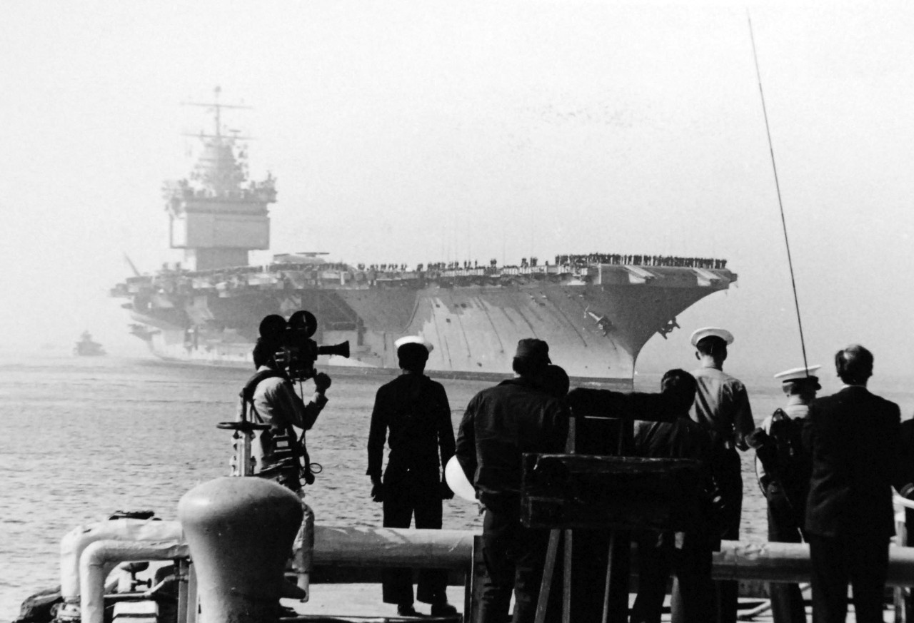 428-GX-USN-1151839:   USS Enterprise (CVAN-65), 1972. Photographers and reporters await the docking of the nuclear-powered aircraft carrier as she returns to Naval Air Station, Alameda, California, from duty in Asian waters  Official U.S. Navy Photograph, now in the collections of the National Archives.  (2017/11/29).  