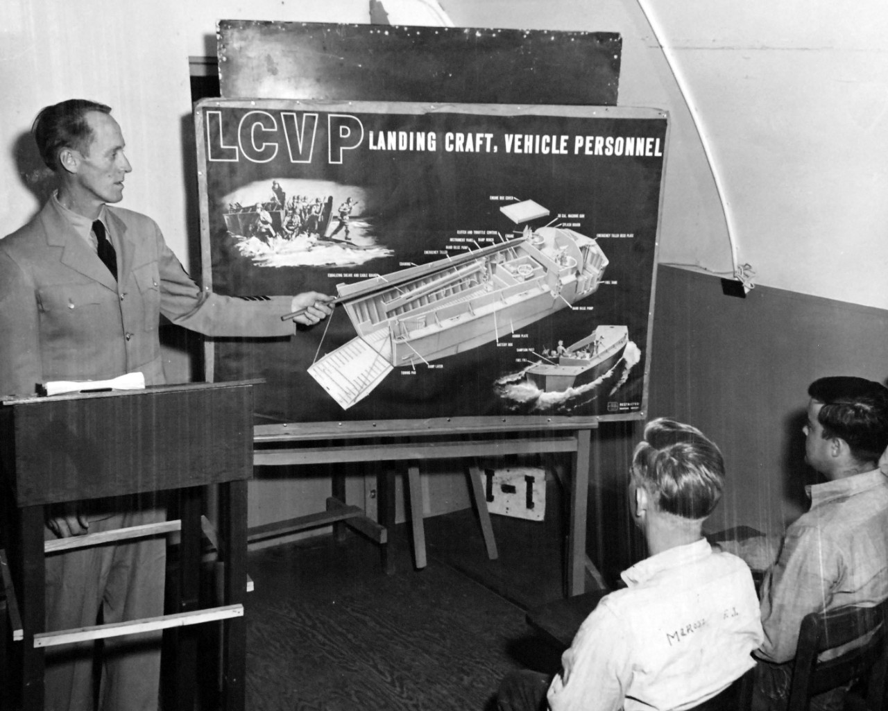 80-G-634812:   Landing Craft Control School, Naval Amphibious Base, Coronado, California, February 1, 1954.  Students receive training from BMC Paul A. Warden, USN, who explains to SN Frank J. Marosz and SN James E. pace the different features of the LCVP in a class on boat nomenclature.  Official U.S. Navy Photograph, now in the collections of the National Archives.  
