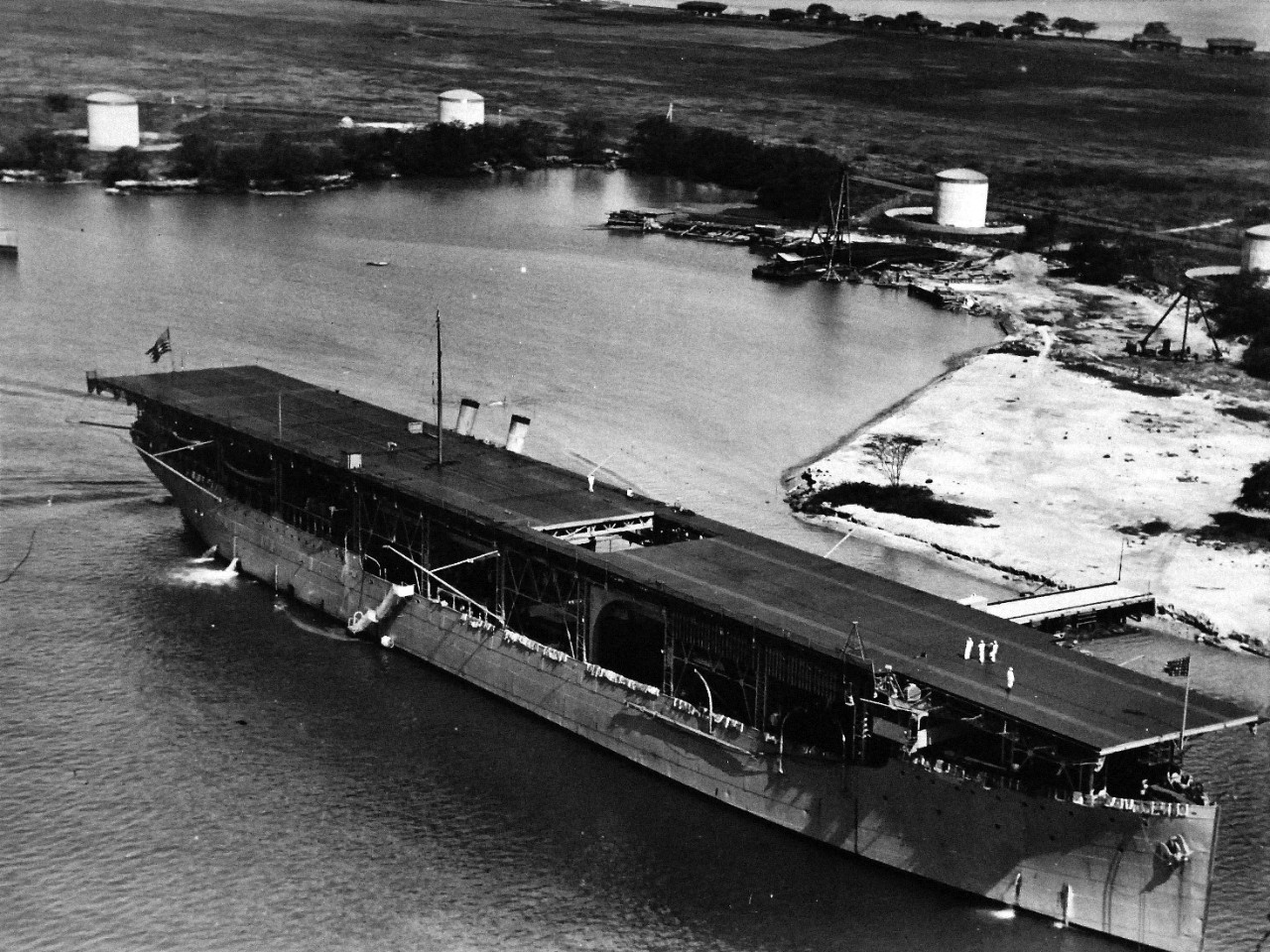 80-G-185927:   USS Langley (CV 1), 1925.   Langley going by the oil docks at Pearl Harbor, Territory of Hawaii, May 4, 1925. Official  U.S. Navy photograph, now in the collections of the National Archives.  (2015/12/22).