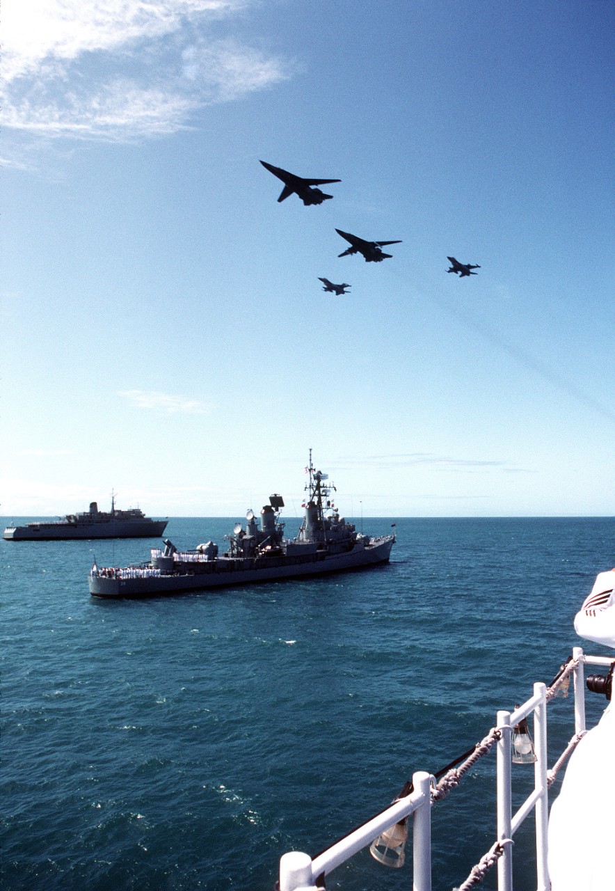 330-CFD-DN-ST-92-09821: USS Luce (DDG-38), 1992.     F-16 Fighting Falcon and F-111 aircraft fly in formation over the guided missile destroyer USS Luce (DDG-38) and a dock landing ship. The vessels and aircraft are taking part in ceremonies commemorating the 50th anniversary of the Battle of the Coral Sea.  Photograph received, May 1992.   Official U.S. Navy Photograph, now in the collections of the National Archives.  