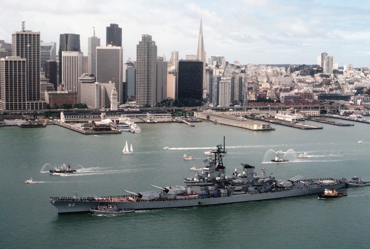 300-CFD-DN-ST-86-07166: USS Missouri (BB-63), 1986.  Large harbor tugs assist the battleship USS Missouri (BB-63) into port for recommissioning.  In the background is the San Francisco skyline.  Official U.S. Navy Photograph, now in the collections of the U.S. National Archives - Online Public Access. 