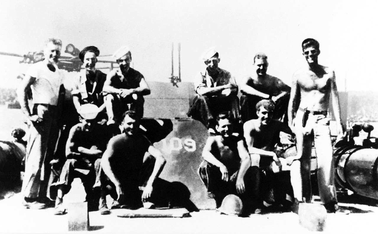 306-ST-649-9:  USS PT-109, 1943.    Lieutenant John F. Kennedy, USNR, (standing, far right) with other crewmen onboard USS PT-109 at a South Pacific Naval Base, 1943   U.S. Information Agency Photograph, now in the collections of the National Archives.  (2017/10/18).