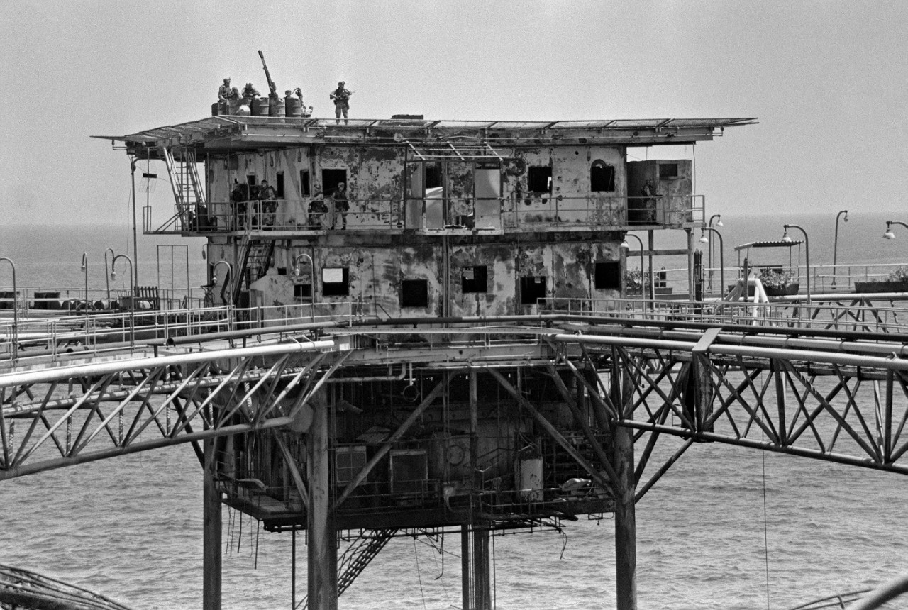 330-CFD-DN-SN-89-03136:   Operation Praying Mantis, April 14, 1988. A view of an Iranian oil platform after being strafed by US forces.  Marines raided the platform to gather intelligence data and military equipment used by Iranians.  The platform was later destroyed by gunfire from US destroyers in retaliation for the Iranian mining of the guided missile frigate USS Samuel B. Roberts (FFG-58) in the Persian Gulf.  U.S. Navy Photograph, now in the collections of the U.S. National Archives:  Online Public Access.   U.S. Navy Photograph, now in the collections of the U.S. National Archives.   