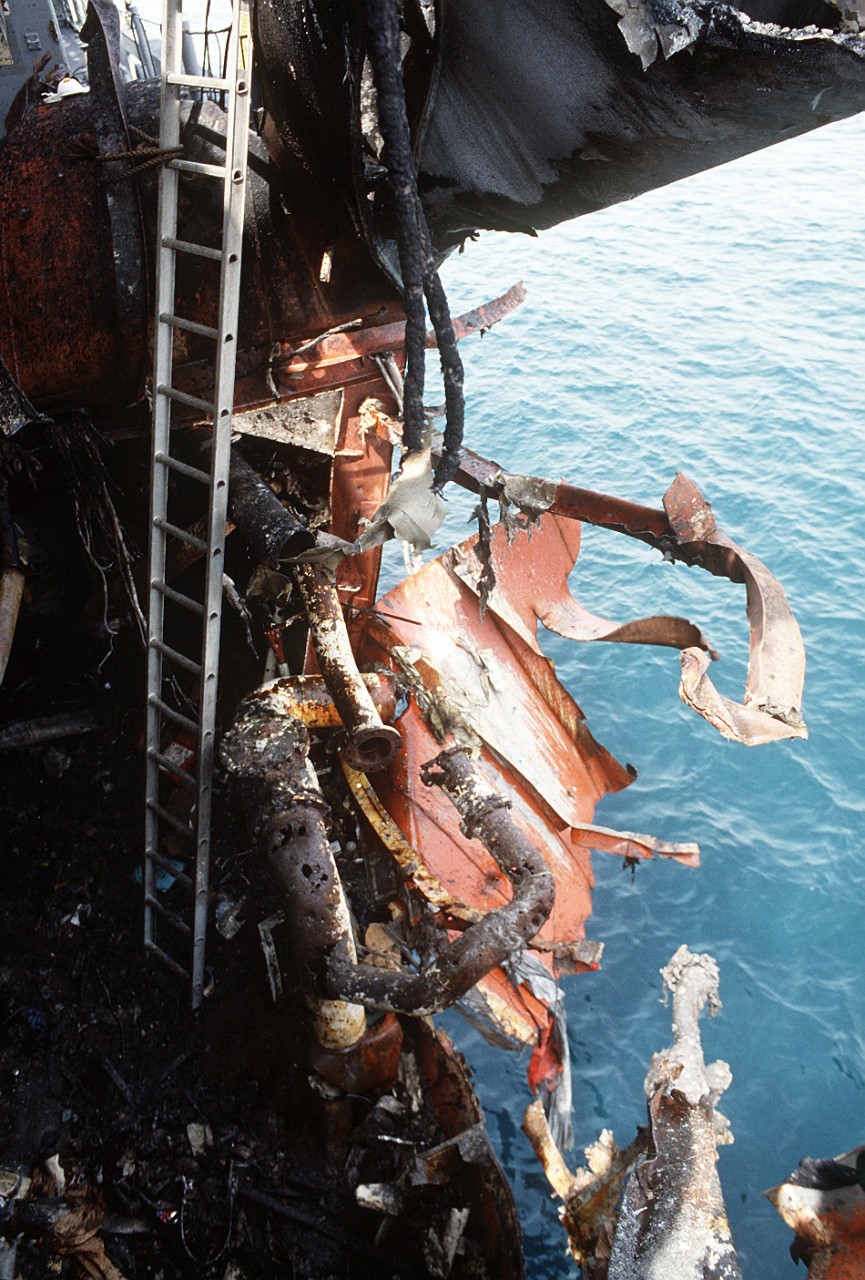 330-CFD-DN-ST-87-06418:   USS Stark (FFG-31), 1988. A close-up view of damage to the guided missile frigate USS Stark (FFG-31) after it was struck by an Iraqi-launched Exocet missile.  U.S. Navy Photograph, now in the collections of the U.S. National Archives.